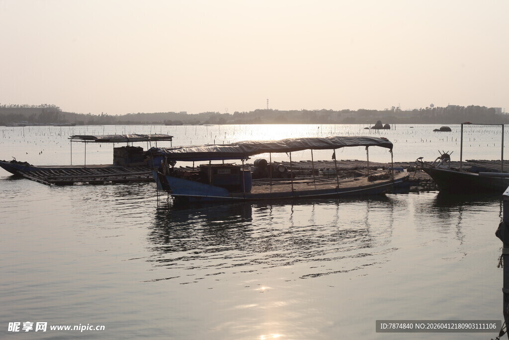 湛江夕阳下宁静的水边停泊船只