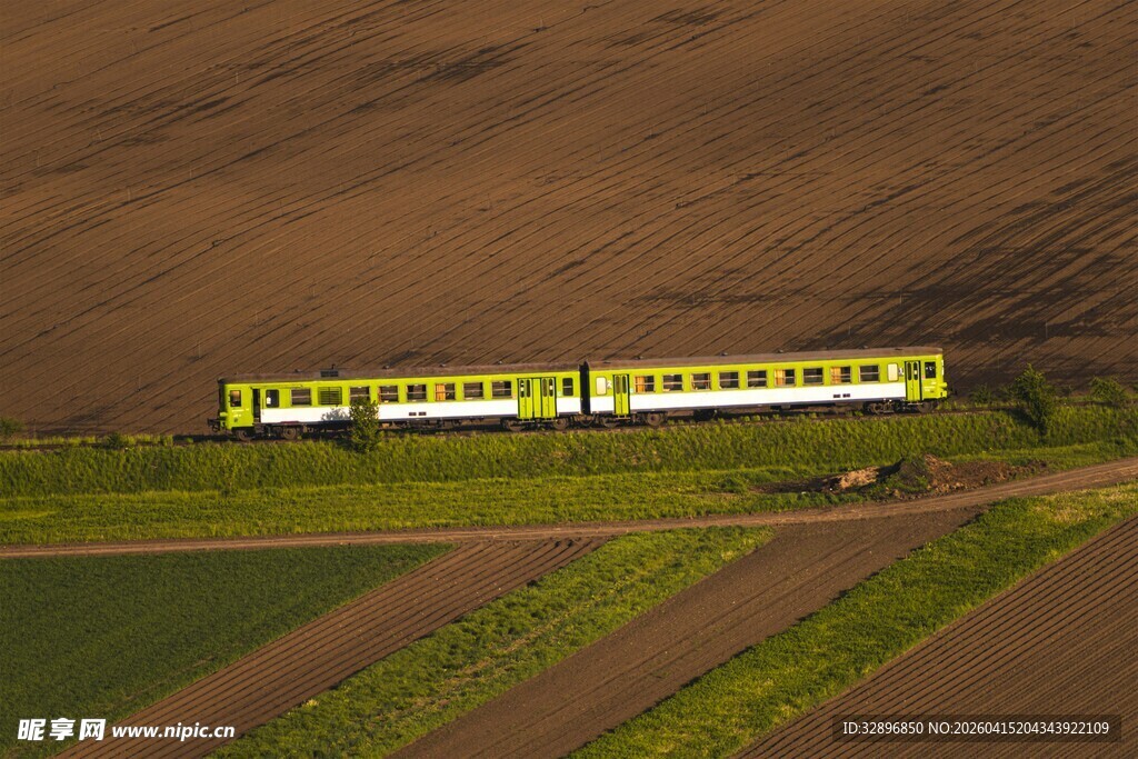田野间行驶的黄绿相间列车