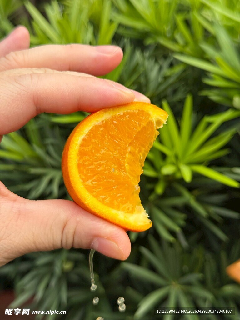 手拿咬过的新鲜橙子