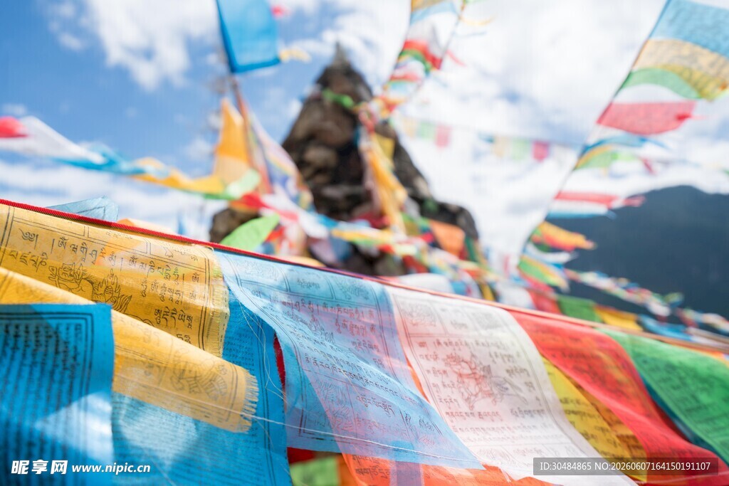 五彩经幡飘扬于蓝天白云下
