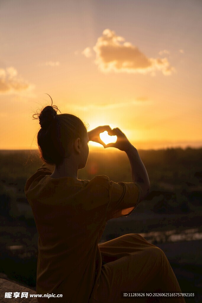 夕阳下女子比心美好瞬间