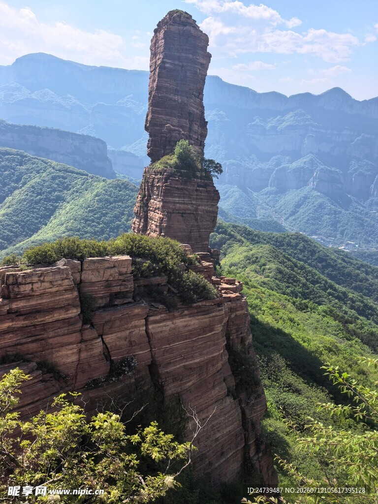奇峰屹立于青山绿野间
