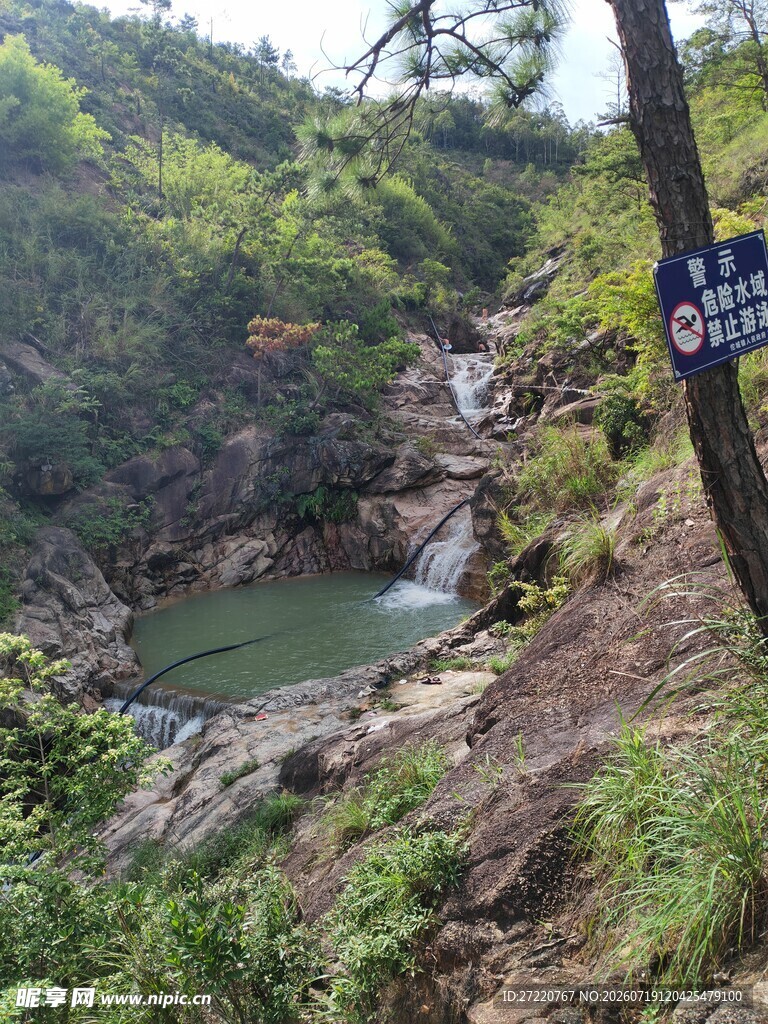 山间溪流旁的蓝色指示牌