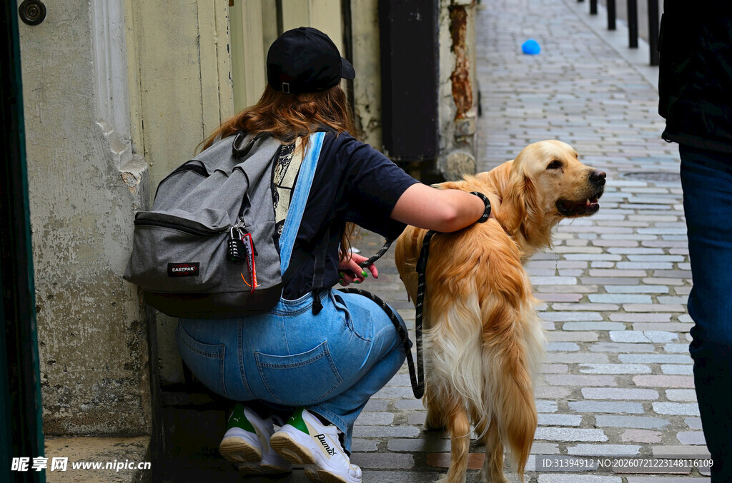 女子街边亲昵互动金毛犬