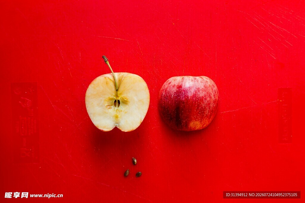 红底上的鲜苹果与半颗果