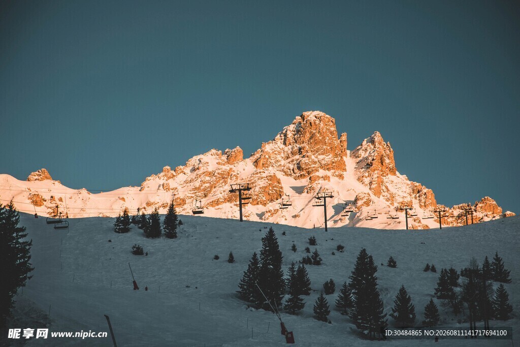 雪山映夕阳下的森林美景