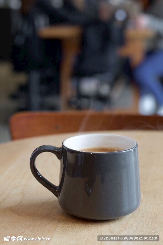 木桌上的灰色咖啡杯