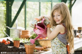 正在给花浇水的漂亮小女孩