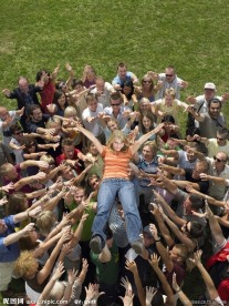 草地上热烈欢呼高高抬起美女的人群