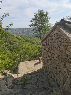 山间石屋旁的自然景致