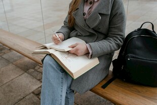 女子长椅上专注阅读书籍