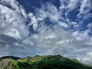 蓝天白云下的翠绿山峦