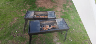 户外烧烤架置于绿草地