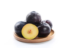 新鲜黑布林摆放在木盘上