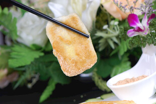 筷子夹起的美味金黄糕点