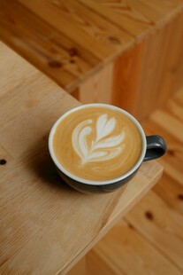 木质桌上的精美拉花咖啡