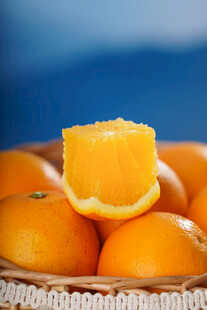 一瓣橙子置于满篮橙中