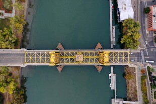 航拍黄色桥梁横跨绿水