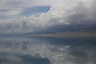 平静湖面映着天空与云朵