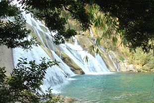 山间飞瀑下的碧绿潭水