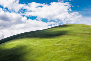 翠绿山坡上的蓝天白云