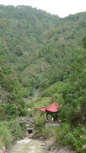 山间溪流旁的红顶建筑