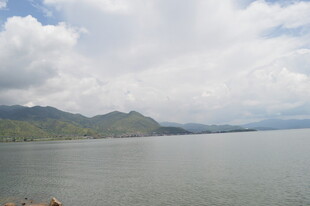 湖畔山峦与蓝天白云美景