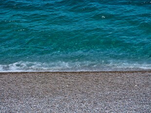 蓝绿色海水与砾石海滩