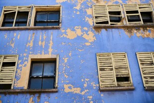 蓝色斑驳墙面的老旧窗户