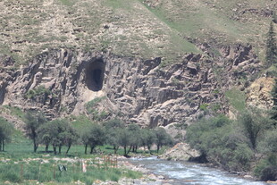 山间洞穴旁的溪流与绿植