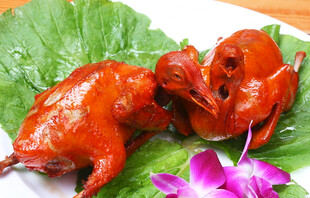 美味烤乳鸽摆于绿叶之上