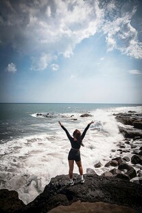 海边少女张开双臂拥抱自然