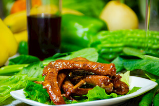 美味卤鸭掌摆于翠绿蔬菜上