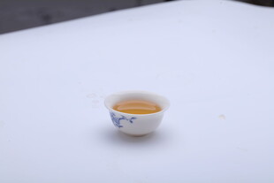 精致小茶杯中的金黄茶汤