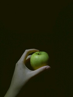 手托青苹果特写
