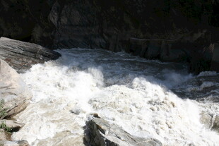湍急溪流冲击岩石景象