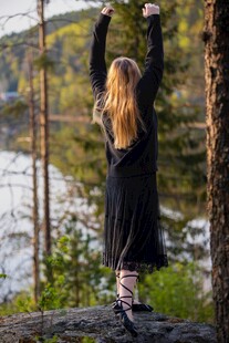 女子于林间湖畔舒展双臂