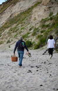海边徒步者携桶漫步沙滩