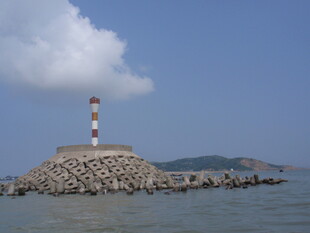 海上灯塔屹立于石堆之上