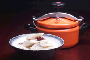 橙色炖锅与碗中美食