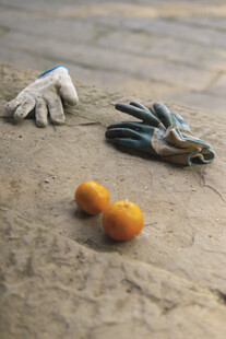 沙滩上的手套与橘子