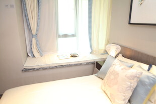 温馨卧室窗边舒适床铺一角