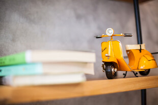 黄色小摩托摆件置于书架