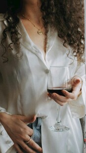 卷发女子手持红酒