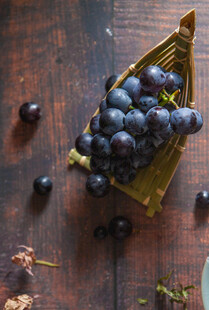 木桌上的紫葡萄与小果