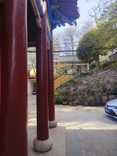 中式廊柱旁的蓝色汽车