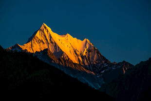 金色霞光映照巍峨山峰