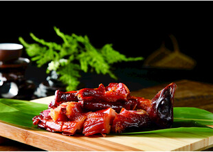 美味卤味鸭头摆于绿叶上