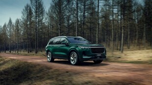 绿色SUV行驶在林间土路