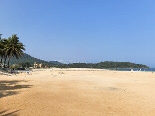 美丽沙滩与远处青山椰树